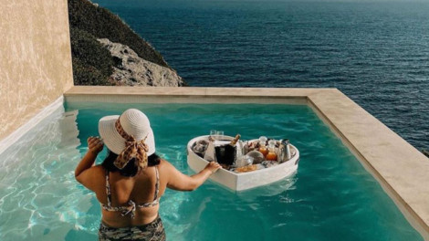 Floating Heart Tray inside a pool with lunch food on the tray